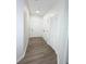 Hallway with luxury vinyl plank flooring and two storage closets at 13512 Turtle Marsh Loop # 729, Orlando, FL 32837