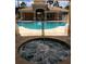 View of hot tub with swirling water, pool and clubhouse in the background at 13512 Turtle Marsh Loop # 729, Orlando, FL 32837