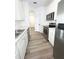 Galley kitchen with stainless steel appliances and white cabinets at 13512 Turtle Marsh Loop # 729, Orlando, FL 32837