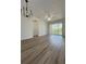 Spacious living room with light gray wood-look floors and sliding doors to a screened balcony at 13512 Turtle Marsh Loop # 729, Orlando, FL 32837
