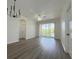 Bright living room with sliding doors to a balcony and modern chandelier at 13512 Turtle Marsh Loop # 729, Orlando, FL 32837