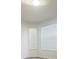 Bright room with light gray wood floors and two windows with horizontal blinds at 13512 Turtle Marsh Loop # 729, Orlando, FL 32837