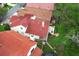 Aerial view of a home with a tile roof, backyard patio, and lush, mature landscaping at 1364 Augusta National Blvd, Winter Springs, FL 32708