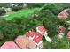 Overhead shot showcasing a home, pool, and golf course in a lush, green setting at 1364 Augusta National Blvd, Winter Springs, FL 32708