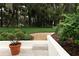 Beautifully landscaped backyard with a charming patio and scenic views at 1364 Augusta National Blvd, Winter Springs, FL 32708