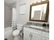 Bathroom featuring granite countertops, gray walls, and tub with a shower at 1364 Augusta National Blvd, Winter Springs, FL 32708