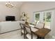 Open concept dining area with a view of the living room and outdoor patio at 1364 Augusta National Blvd, Winter Springs, FL 32708