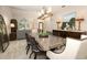 Dining room with stainless steel table, wood accent furniture and lighting fixtures at 1364 Augusta National Blvd, Winter Springs, FL 32708