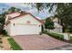 Lovely home with brick driveway, two-car garage, and a charming red tile roof at 1364 Augusta National Blvd, Winter Springs, FL 32708