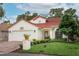 Charming single-Gathering home showcasing a well-manicured lawn, tile roof, and two-car garage at 1364 Augusta National Blvd, Winter Springs, FL 32708