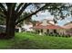 Spacious home featuring a red tile roof, well-manicured lawn, and lush surroundings at 1364 Augusta National Blvd, Winter Springs, FL 32708