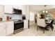 Modern kitchen features stainless steel appliances and a view into the dining area at 1364 Augusta National Blvd, Winter Springs, FL 32708