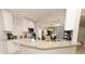 Bright open kitchen with white cabinets, granite counters, and stainless steel appliances at 1364 Augusta National Blvd, Winter Springs, FL 32708