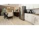 Open kitchen and dining area with stainless steel refrigerator and modern decor at 1364 Augusta National Blvd, Winter Springs, FL 32708