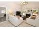 Inviting living room with a fireplace, large TV, and lots of natural light at 1364 Augusta National Blvd, Winter Springs, FL 32708