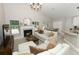 Cozy living room featuring fireplace, plush seating, and access to the patio at 1364 Augusta National Blvd, Winter Springs, FL 32708