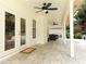 Charming covered patio with tile flooring, ceiling fans, and outdoor seating area at 1364 Augusta National Blvd, Winter Springs, FL 32708