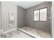 Elegant walk-in shower featuring gray tile, mosaic flooring, and a window at 1364 Augusta National Blvd, Winter Springs, FL 32708