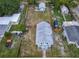 Aerial view of a two-story home with a large fenced backyard and additional storage buildings on the property at 1504 Indiana Ave, St Cloud, FL 34769