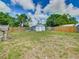 Large backyard featuring a gray shed with white trim, and a wooden fence at 1504 Indiana Ave, St Cloud, FL 34769