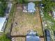 Aerial view of the backyard with wood fence, fire pit, deck and shed at 1504 Indiana Ave, St Cloud, FL 34769