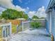 Backyard featuring a gray shed with white trim and a wooden fence, viewed from wood deck at 1504 Indiana Ave, St Cloud, FL 34769