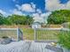 Backyard featuring a gray shed with white trim, and a wooden fence, viewed from wood deck at 1504 Indiana Ave, St Cloud, FL 34769