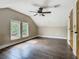 Bright bedroom features hardwood floors, ceiling fan, and two windows providing natural light at 1504 Indiana Ave, St Cloud, FL 34769