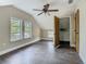 Spacious bedroom features wood floors, a ceiling fan, natural light, and a closet at 1504 Indiana Ave, St Cloud, FL 34769