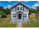 Charming gray two-story home with a well-kept front lawn and a covered entryway for curb appeal at 1504 Indiana Ave, St Cloud, FL 34769