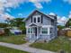Charming gray two-story home with a well-kept front lawn and a covered entryway for curb appeal at 1504 Indiana Ave, St Cloud, FL 34769