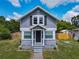 Charming gray two-story home with a well-kept front lawn, covered entryway, and tidy landscaping at 1504 Indiana Ave, St Cloud, FL 34769