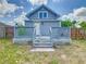 Home exterior featuring gray siding, white trim, small front deck, and yard at 1504 Indiana Ave, St Cloud, FL 34769