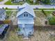 Aerial view of the home which has a metal roof, small front porch, and is surrounded by a wooden fence at 1504 Indiana Ave, St Cloud, FL 34769