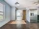 Spacious kitchen with stainless steel refrigerator and view through a doorway at 1504 Indiana Ave, St Cloud, FL 34769