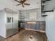 Kitchen with stainless steel refrigerator and industrial shelving at 1504 Indiana Ave, St Cloud, FL 34769