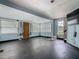 Bright living room with front door, windows and original wood floors awaiting restoration at 1504 Indiana Ave, St Cloud, FL 34769