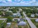 Aerial neighborhood view, capturing streets, houses, and the expansive ocean horizon at 1504 Indiana Ave, St Cloud, FL 34769