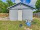 The shed is made of concrete blocks and has a white door at 1504 Indiana Ave, St Cloud, FL 34769