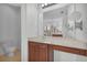 Bathroom vanity area with a large mirror, lighting fixtures, and pull out magnifying mirror at 1560 Canopy Pasture Dr, St Cloud, FL 34771