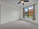 Comfortable bedroom with neutral carpet, a ceiling fan, and a view to the backyard at 1560 Canopy Pasture Dr, St Cloud, FL 34771