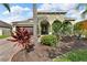 Inviting home with well-maintained landscaping and an arched entryway at 1560 Canopy Pasture Dr, St Cloud, FL 34771