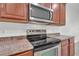 Stainless steel stove and microwave with beautiful granite countertops and modern cabinets at 1560 Canopy Pasture Dr, St Cloud, FL 34771