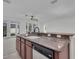 Kitchen bar with granite countertops overlooks the spacious open living area and features a sink at 1560 Canopy Pasture Dr, St Cloud, FL 34771