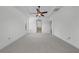 Main bedroom features tray ceiling, a ceiling fan, and an arched entryway into the bathroom at 1560 Canopy Pasture Dr, St Cloud, FL 34771