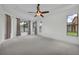 Spacious main bedroom with tray ceiling, large windows, and neutral carpeting at 1560 Canopy Pasture Dr, St Cloud, FL 34771