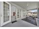 This screened-in patio features an outdoor sitting area and views through large, open sliding glass doors at 1560 Canopy Pasture Dr, St Cloud, FL 34771