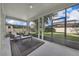 Enjoy this screened patio with outside views, neutral color scheme, and a contemporary seating arrangement at 1560 Canopy Pasture Dr, St Cloud, FL 34771