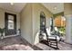 Relaxing front porch featuring comfortable rocking chairs and brick flooring at 1560 Canopy Pasture Dr, St Cloud, FL 34771