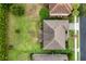 Aerial view showcases the house, surrounding landscaping, and neighboring properties at 1597 Katie Cv, Sanford, FL 32771